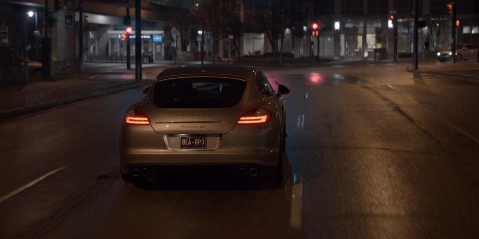 Ryan drives Mary's car towards the intersection as the light changes to red.