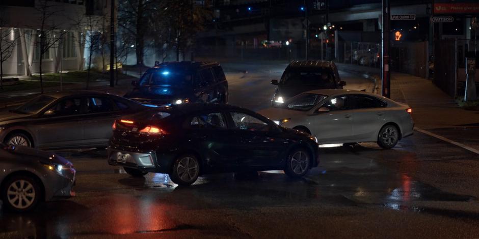 The two Crows SUVs are forced to stop by other cars crossing the intersection.