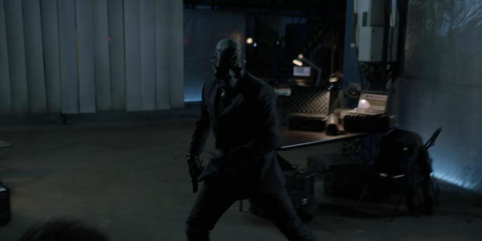 Black Mask turns around to fight Ryan.