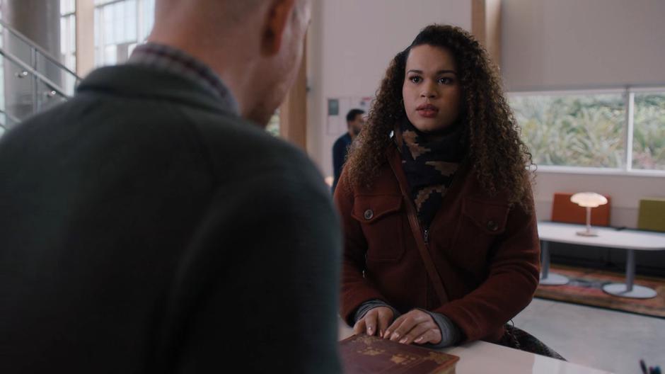 The librarian at the rare books counter tells Josefina that only registered students can check out rare books.