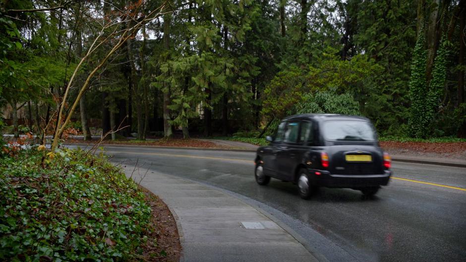 The taxi drives off after leaving Astra by the side of the road.