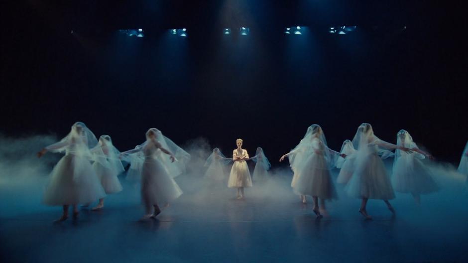 The dancers perform onstage during the recital.