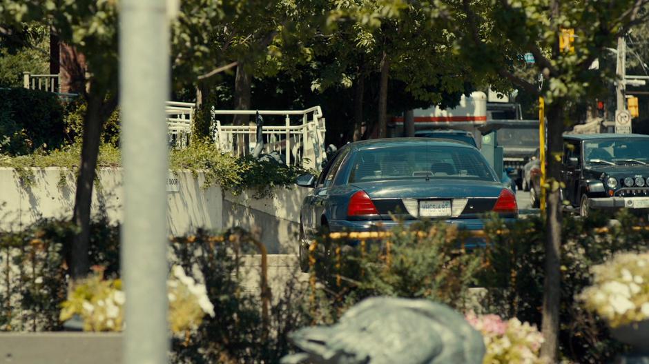 A suspicious car sits near the school.