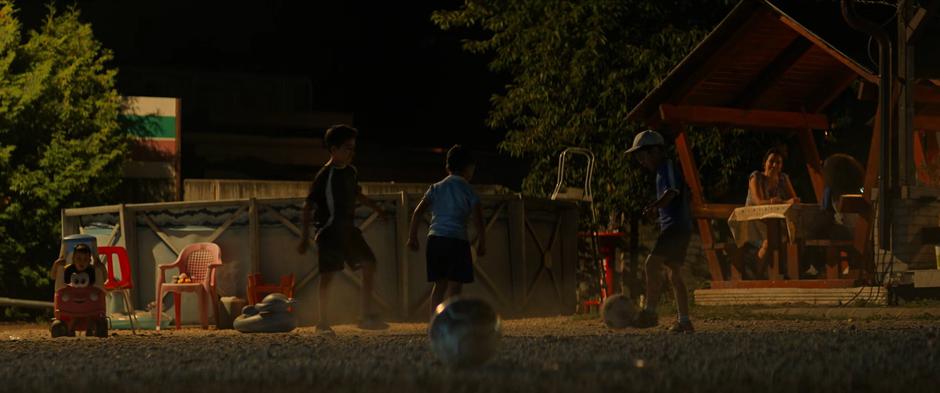 Kids play soccer in the lot next to the picnic area.