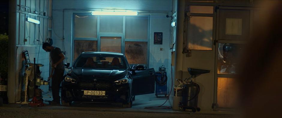 A man closes up the small auto shop next door.