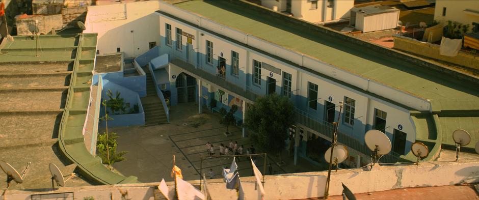 Students run out into the courtyard as the bell rings.