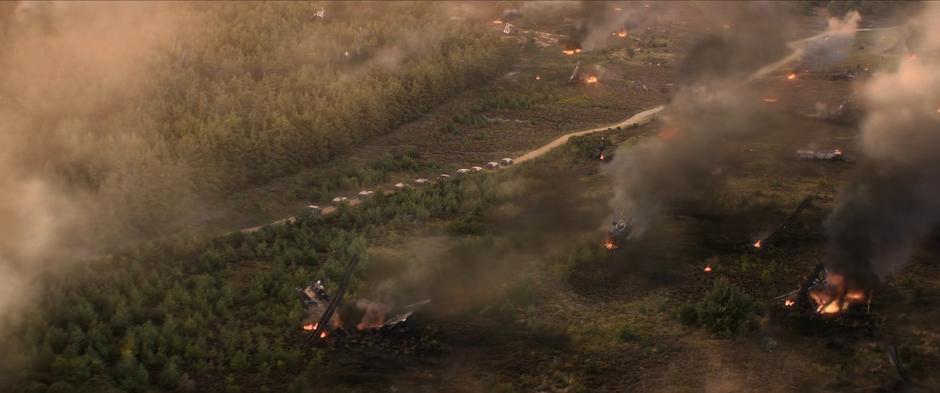 A line of government vehicles approach the crash site.
