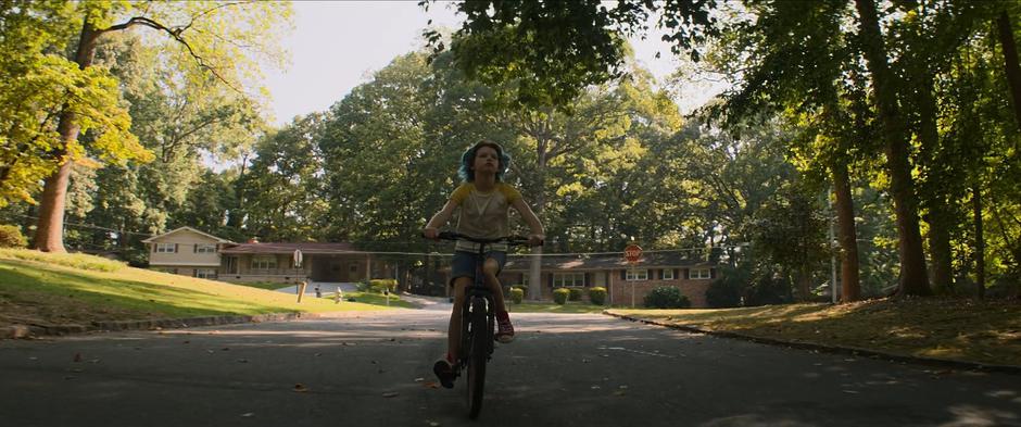 Young Natasha rides her bike through the shade in Ohio.