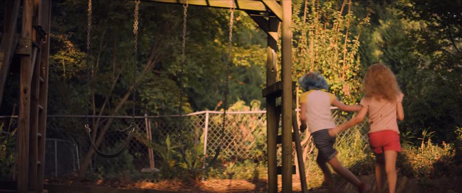 Yelena chases after Natasha around the playground.