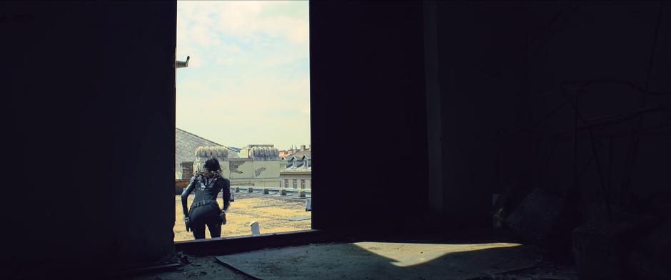 Ingrid dashes from the tower across the rooftop.