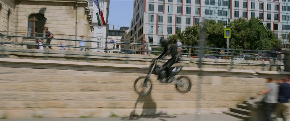 The Widow jumps down the stairs to the waterfront road to continue the pursuit.