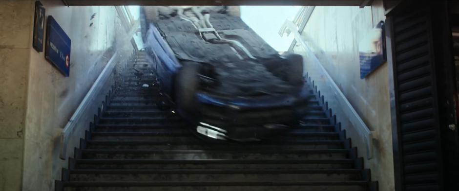 The stolen vehicle slides down the stairs into the subway station.