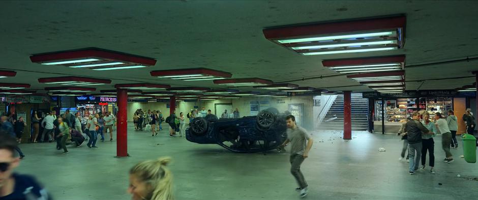 People flee as the car slides into the subway station.