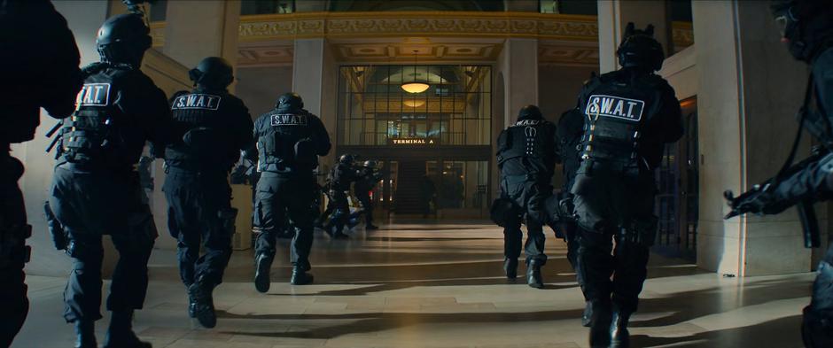 S.W.A.T. officers begin to converge inside the station.