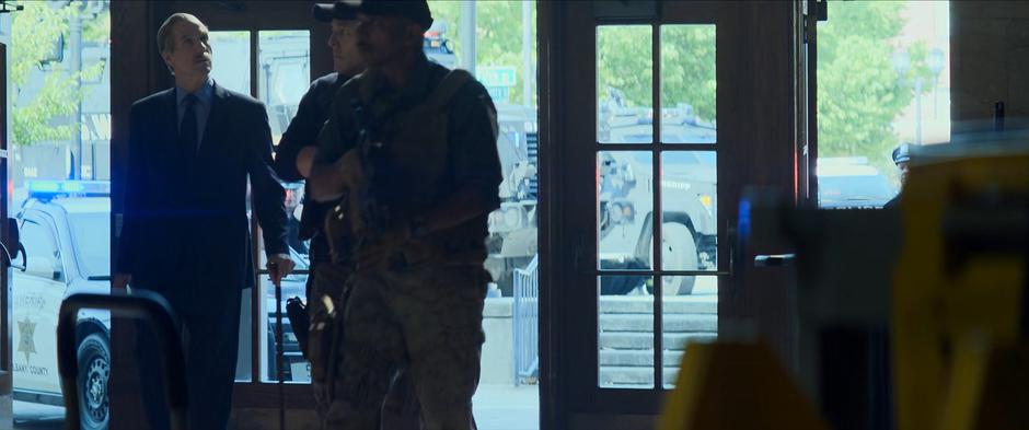 Secretary Ross looks around as he is escorted inside the station.