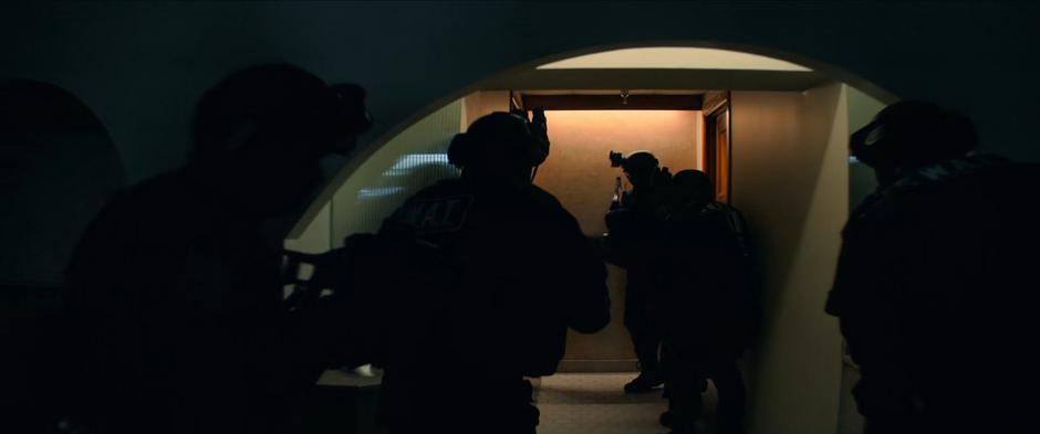 Agents smash open the bathroom door where they believe Natasha is hiding.