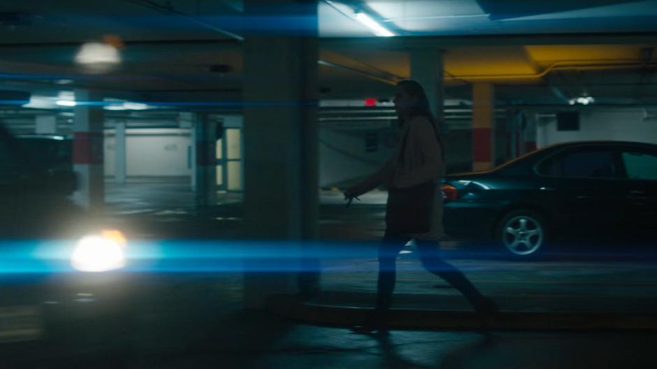 A car drives pass as Waverly rushes towards her car.