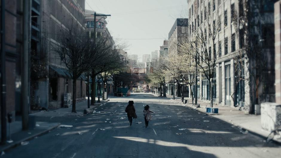 Macy and Maggie rush off down the empty street.