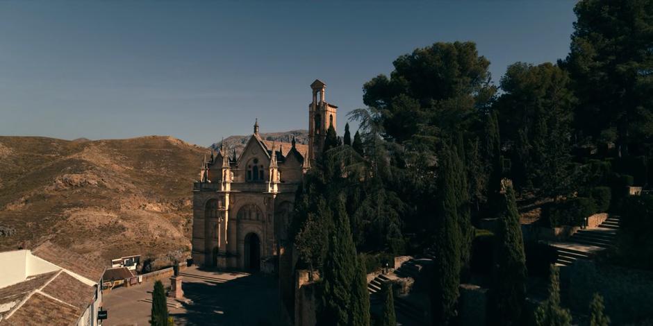 Establishing shot of the Cat's Cradle sitting on the side of the hill surrounded by trees.