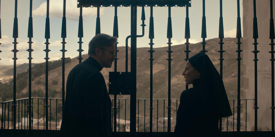 Father Vincent and Mother Superion talk in front of the gate looking down over the valley.