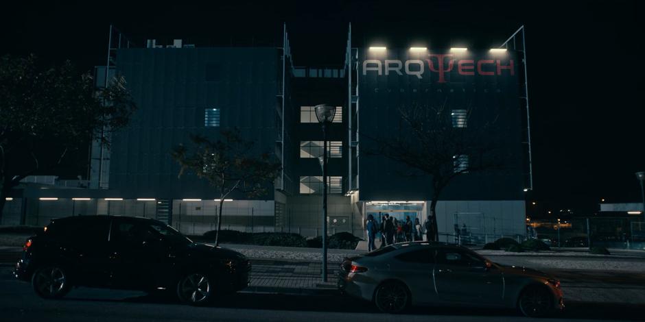 People gather outside the Arq Tech building at night for the party.