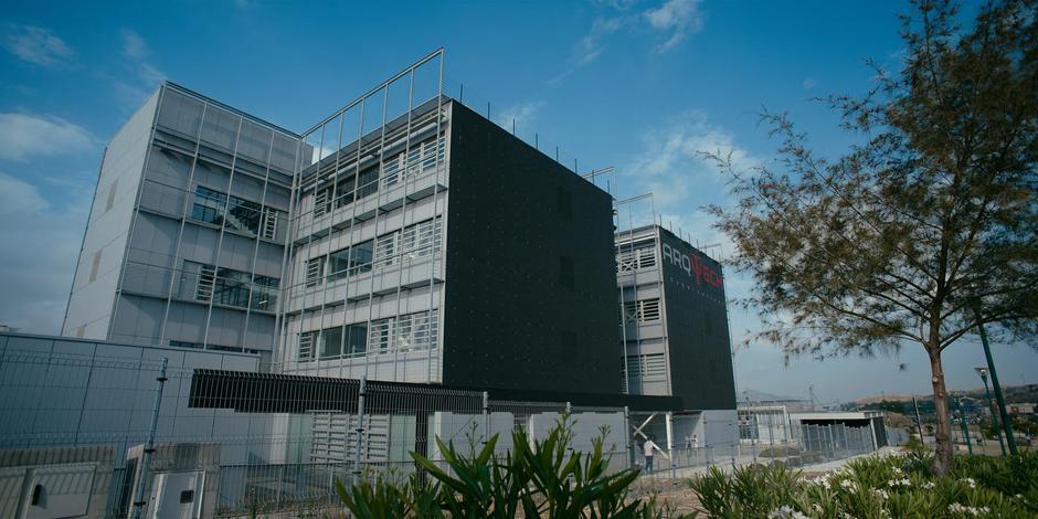 Establishing shot of the exterior of Arq Tech during the daytime.