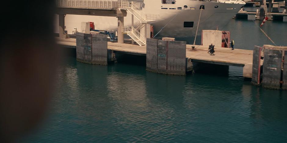 Ava watches as Mary and Lilith run towards the end of the dock as the ferry is departing.