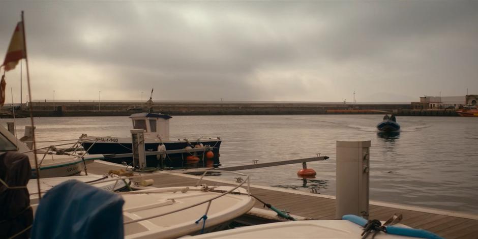 Mary arrives at the dock in a small motorboat.