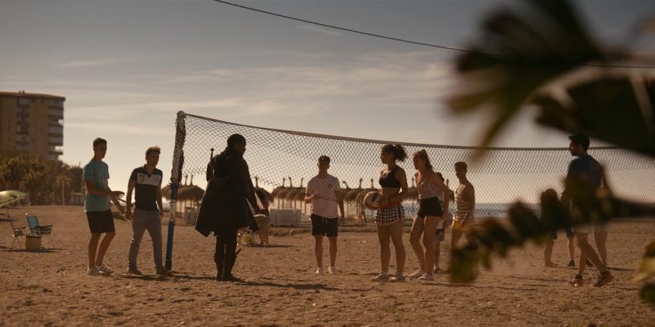 Mary questions some people playing volleyball on the beach if they have seen Ava.