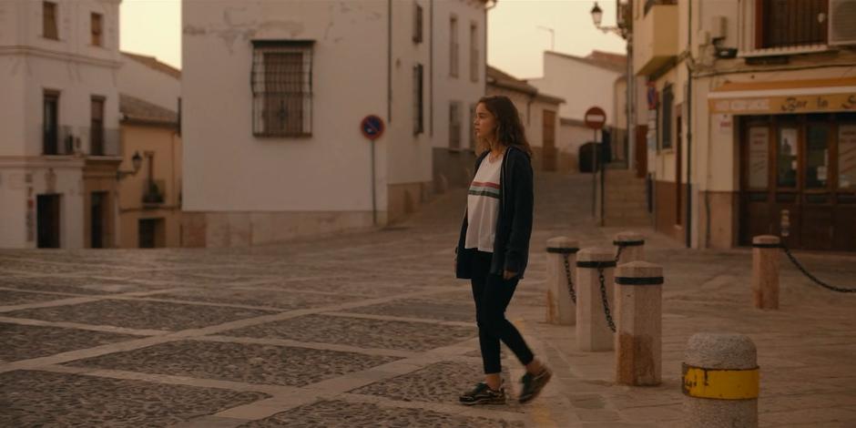 Ava walks into the empty square and searches for signs of anyone else in town.