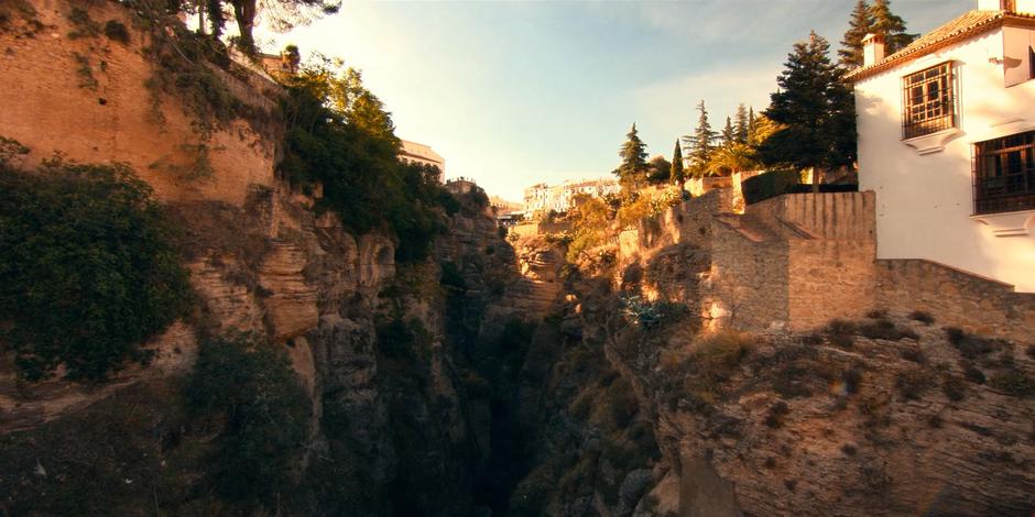 A view down the valley with houses running along the cliffs on either side.