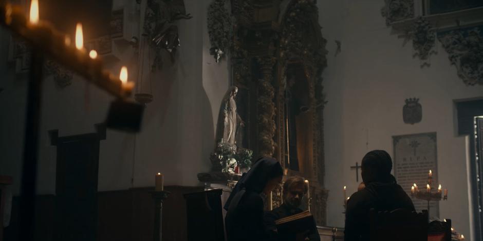 Father Vincent, Mary, and the others watch as Beatrice reads about the burial of Adriel.