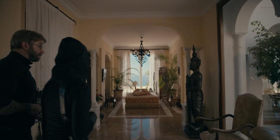 Father Vincent and Mary walk through the villa looking for the owner.