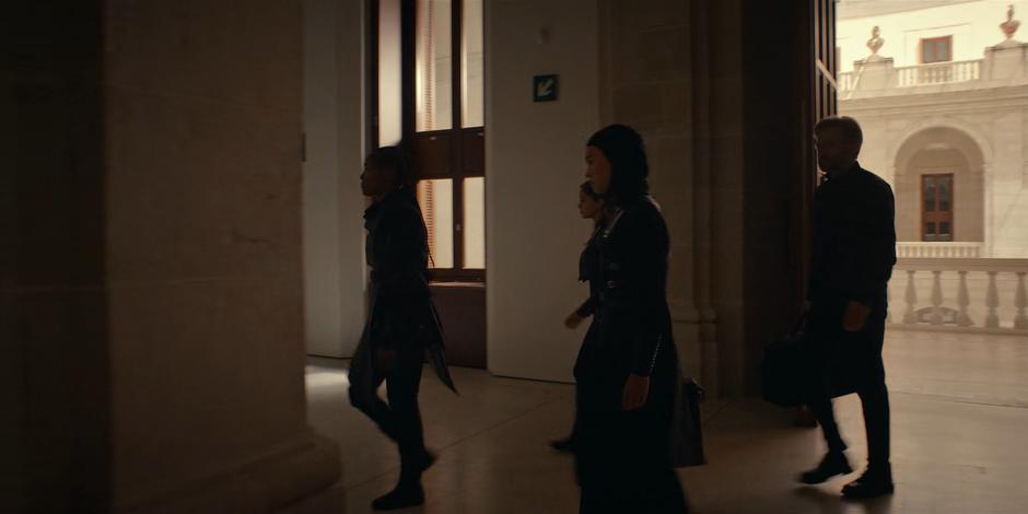 Mary, Ava, Beatrice, and Father Vincent walk towards the stairs.