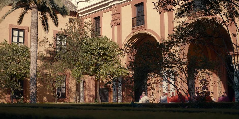 Pope Duretti walks at the head of the group through the coutyard.