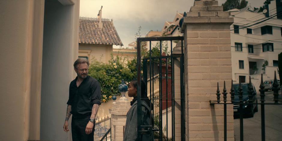 Father Vincent looks back at Mary as they wait at the door.