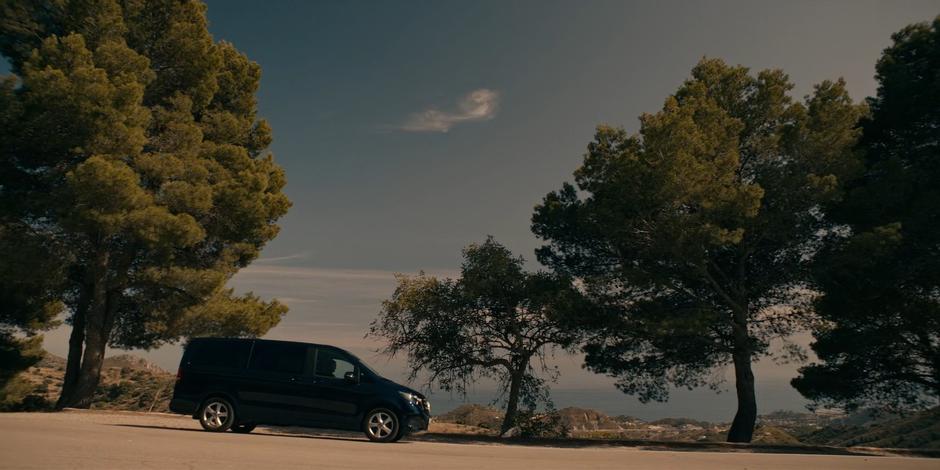 Father Vincent pulls the van to the side of the road.