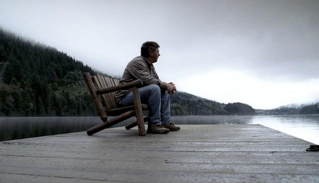 Bill Carlton sits on the dock on the lake.