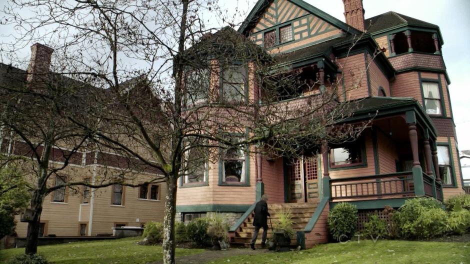 Mr. Gold walks up to the front door of his house.