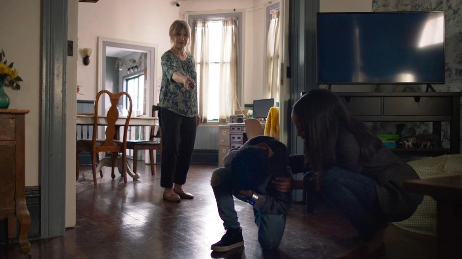 Kelly checks on Joey as Miss Hochschild uses the power-dampening cuff to subdue him.