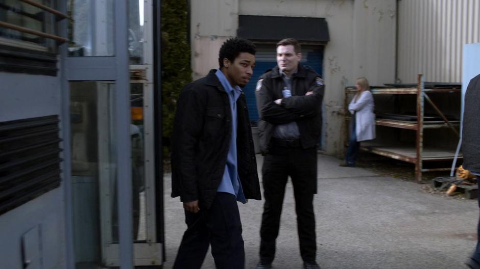 A guard watches as Orlando gets off the prison transport bus with the other members of the work-release program.