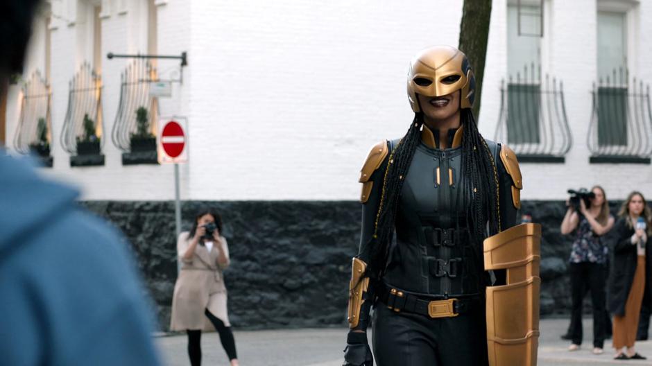 Kelly smiles from behind her Guardian mask as she approaches Orlando and Joey.