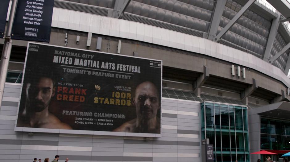A billboard on the outside of the arena advertises the Frank Creed vs. Igor Starros fight.