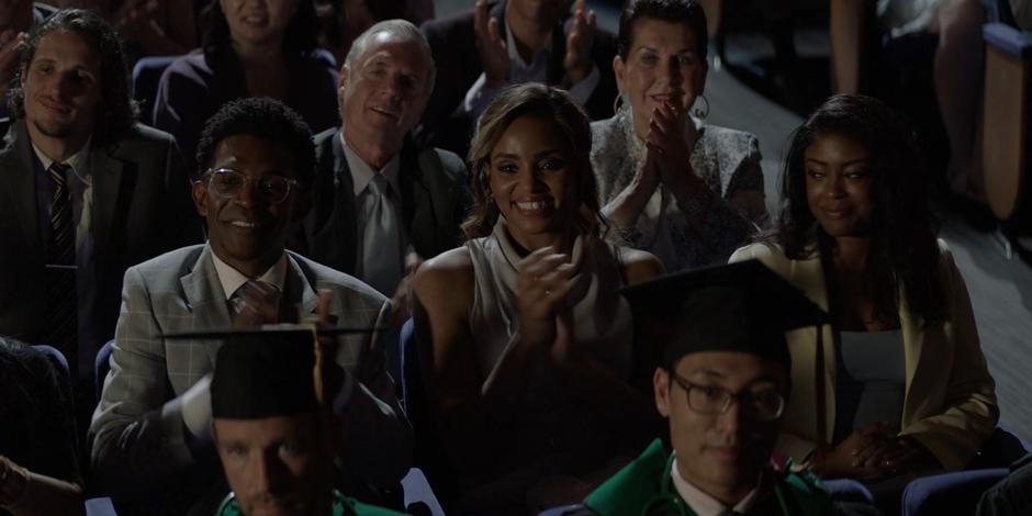 Luke, Sophie, and Ryan clap and look on proudly as Mary comes out for her speech.