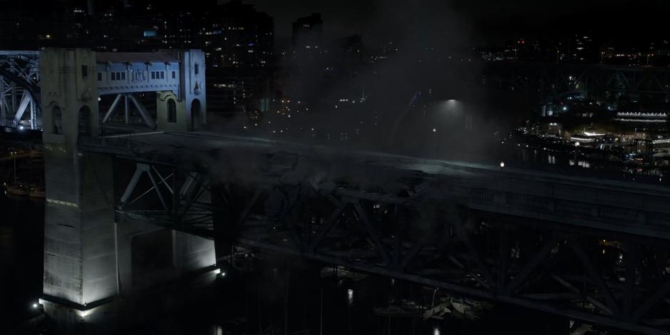 The bridge surface collapses after being destroyed by the bomb from the mercenaries.