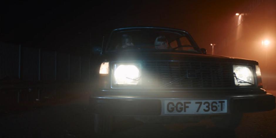 Dan's parents stop the car outside the warehouse on the docks.