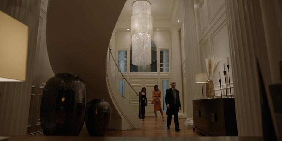 Ryan and Sophie stand in the foyer as the butler walks off.