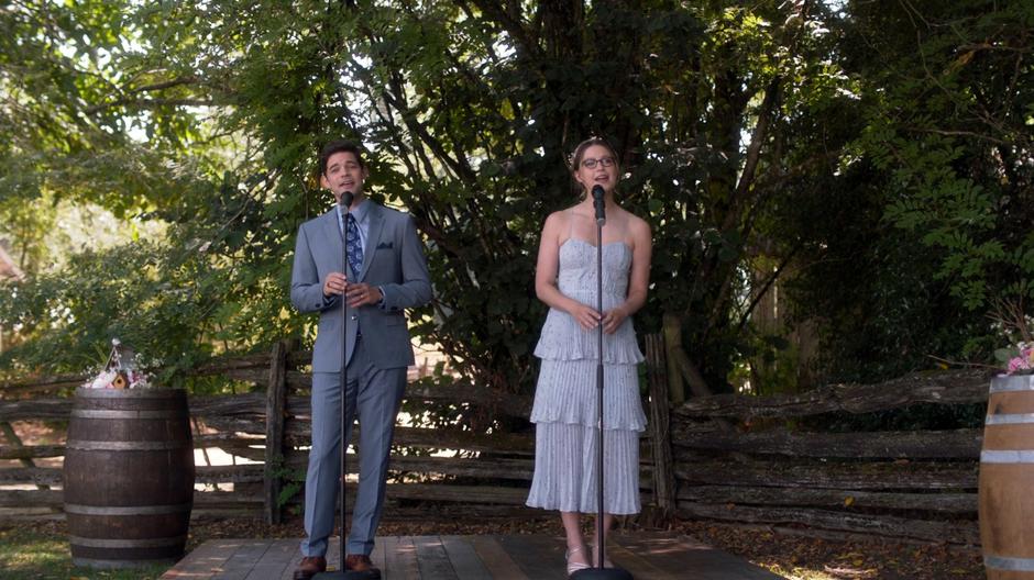 Winn and Kara sing a song during the procession.