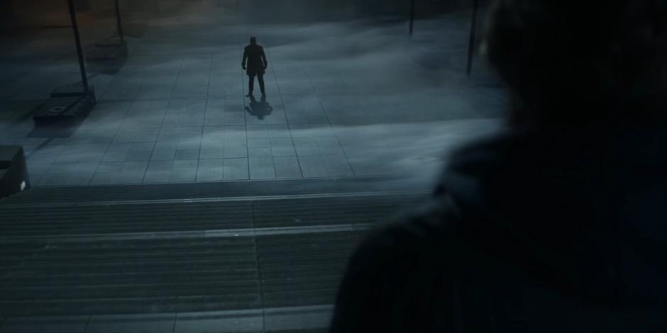 A figure appears in the mist at the bottom of the steps below Dan.