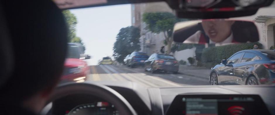 Katy weaves through traffic as she races up the hill.